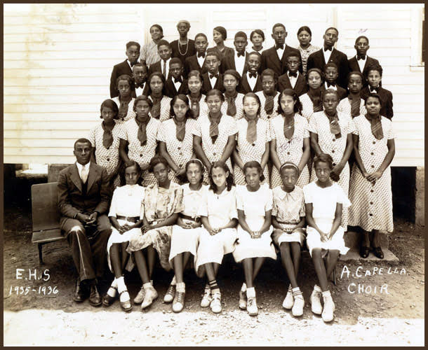A black and white photo of young girls lined up as a choir