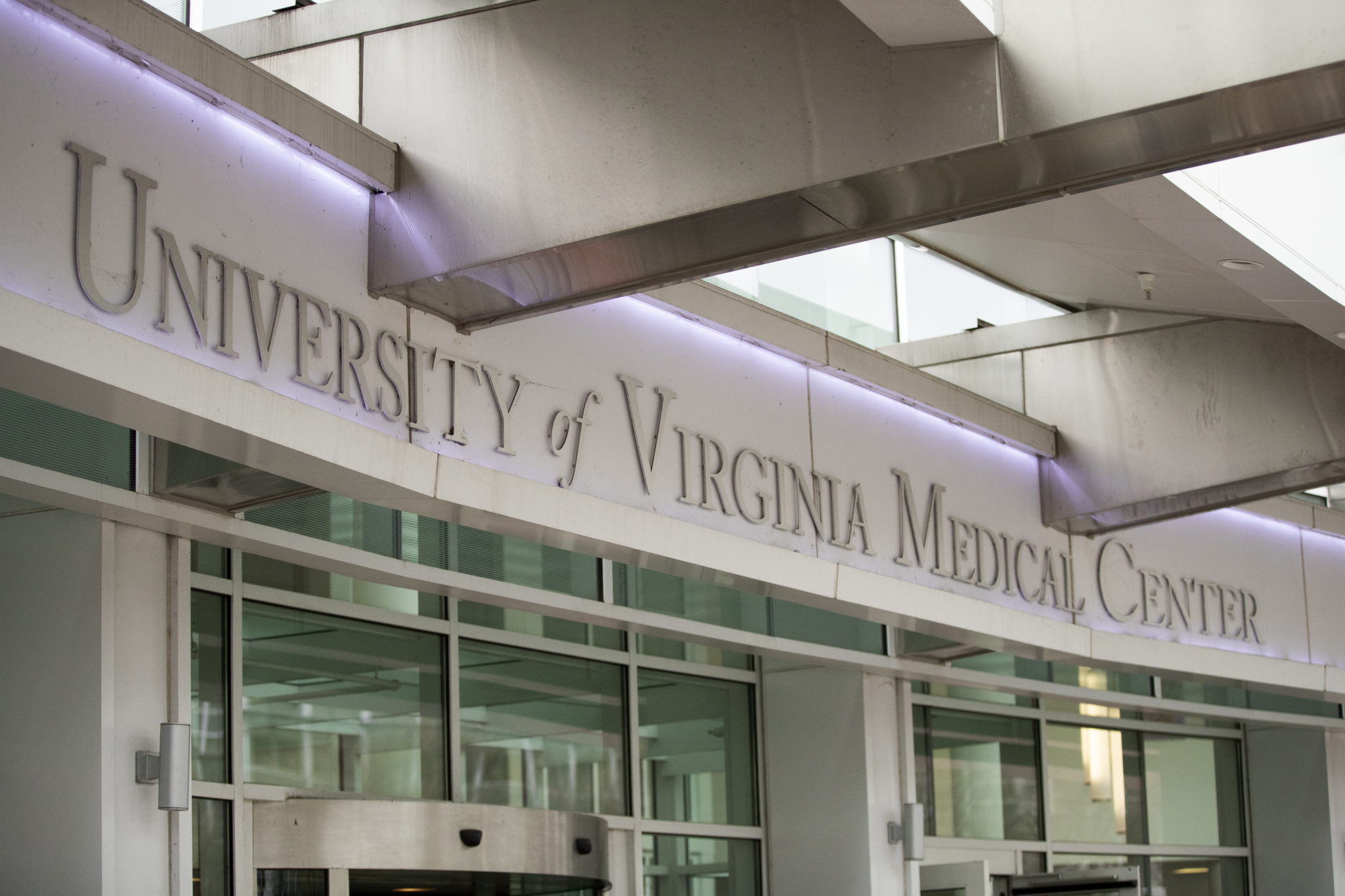 A row of glass doors with a large sign above reading UVA Medical Center