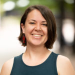 Woman in green blouse smiles