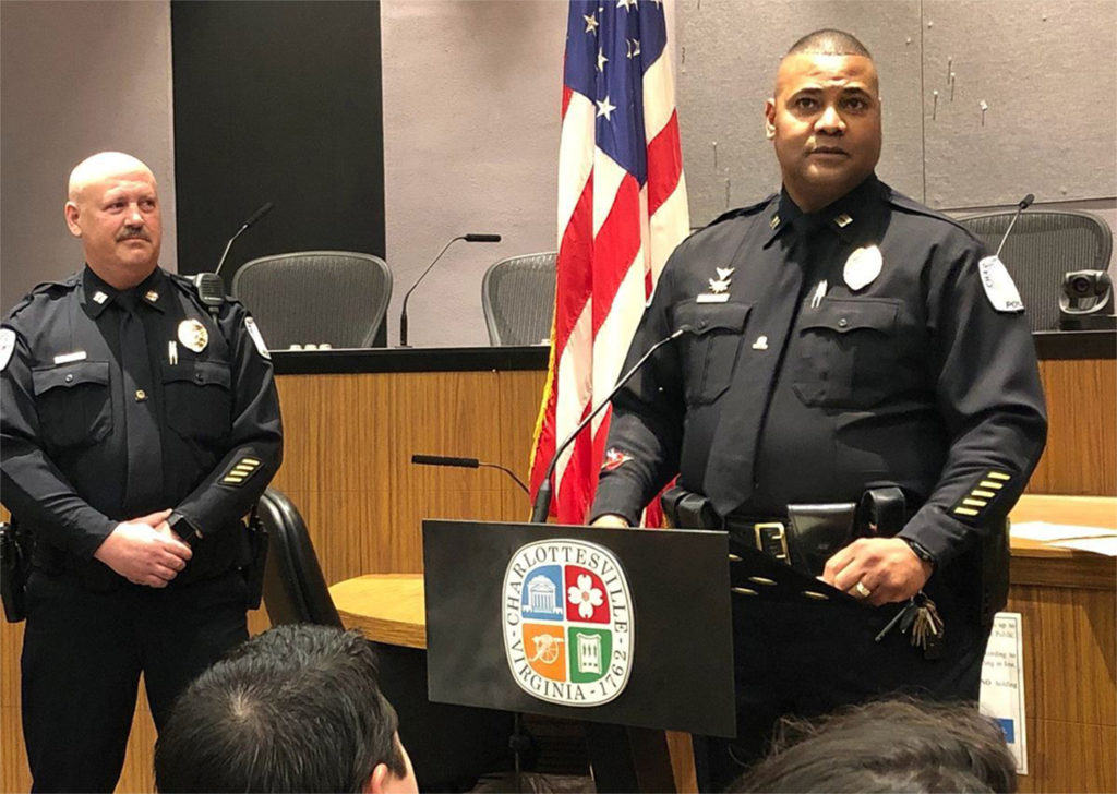 Three photos of men, one at a podium in police uniform and two in suits at a table.