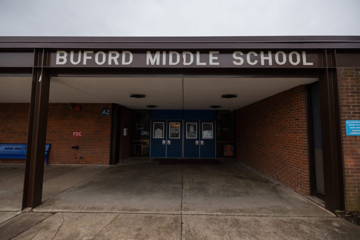 The entrance to a brick building is pictured with a sign above the doors that reads, “Buford Middle School.”