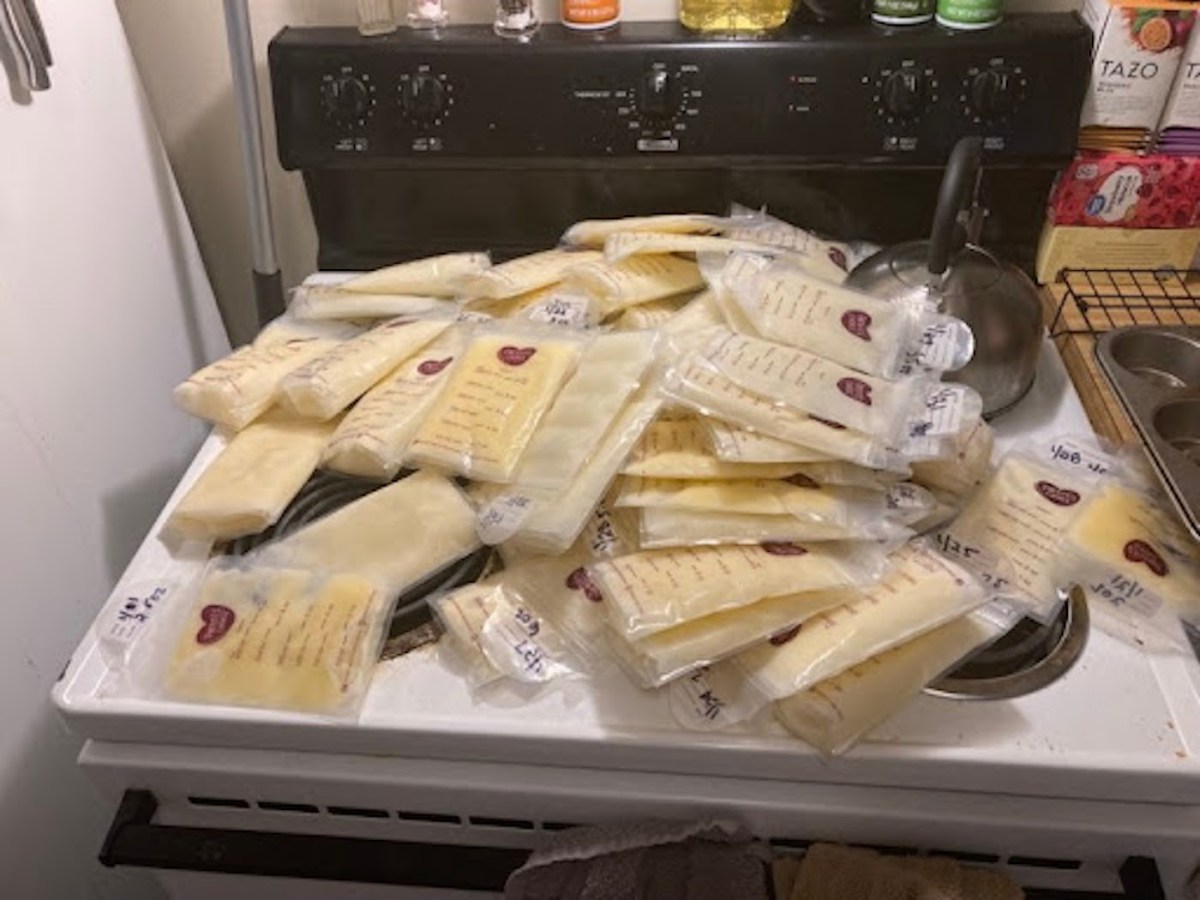 Dozens of frozen bags of breast milk sit scattered on a stove.