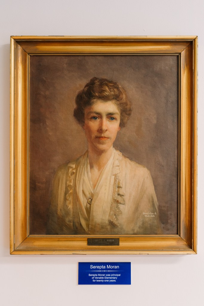 A painting of a woman with light skin and light brown hair.