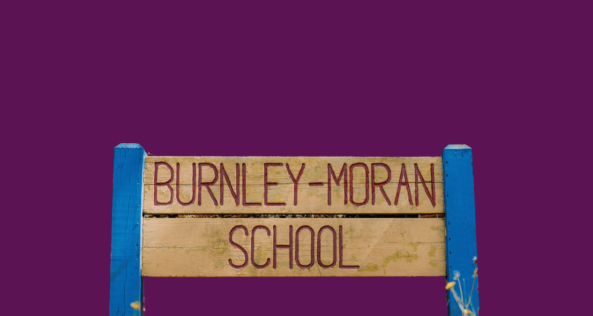 A purple box with a stylized cut-out image of a wooden sigh that reads "Burnley-Moran School"