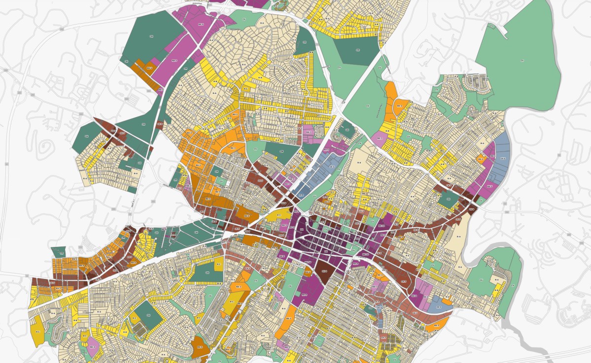 A map of a city shows it different areas colored in purples, greens and yellows.