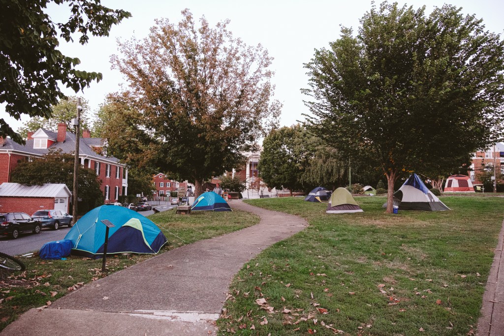 A walkway through a park with tents flanking both sides.
