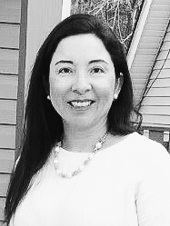 Woman in white shirt and necklace smiling