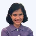 A portrait of a woman, smiling, against a white background
