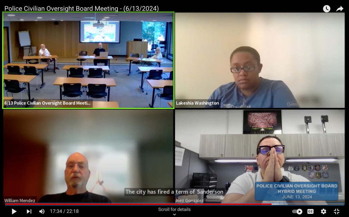 A screenshot shows a Zoom meeting with four windows. In one window, a clearly upset woman holds her hands in front of her face in a prayer position.