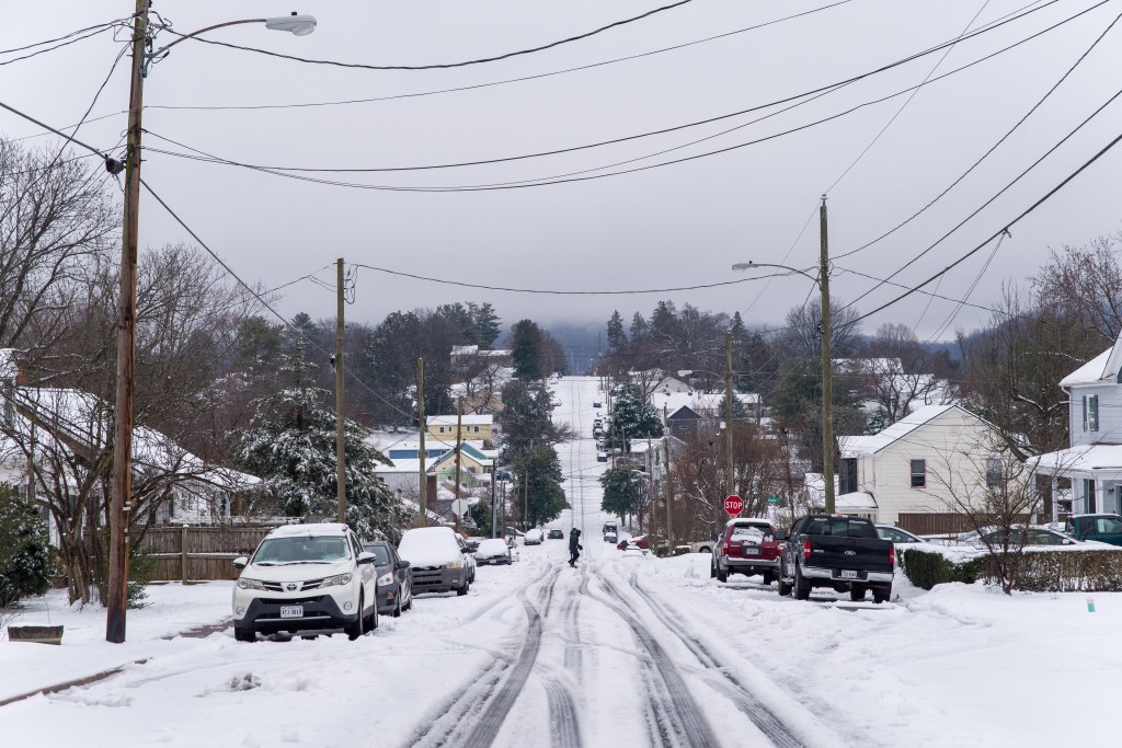 A residential street scene, with people in the distance.