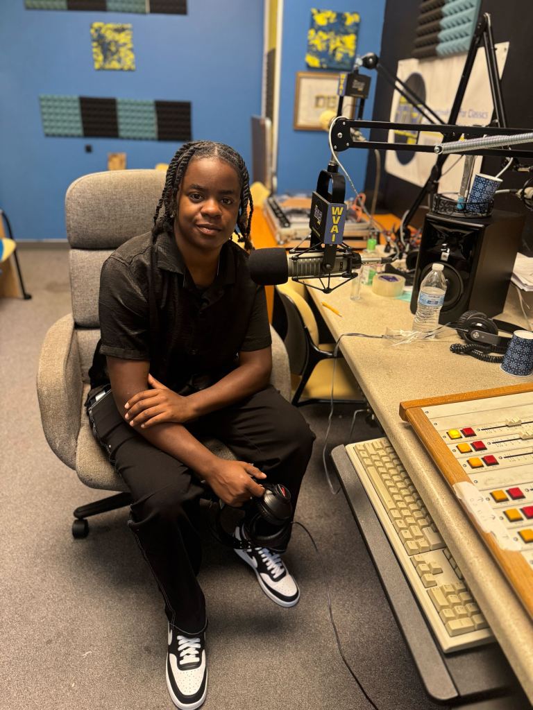 Close-up of a young person in profile, smiling.